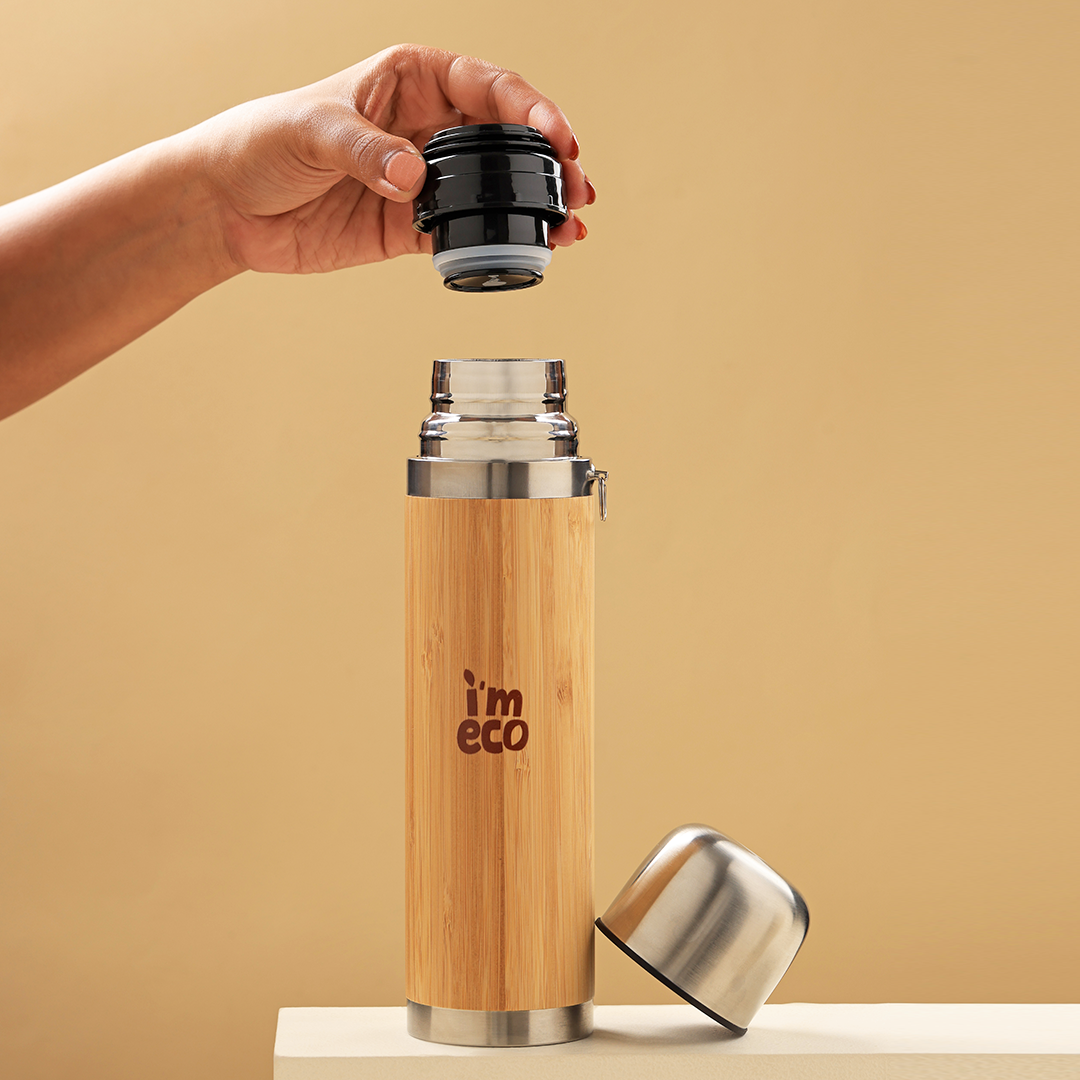 The leakproof and BPA-free bamboo thermos flask is placed on a white surface with its lid open.