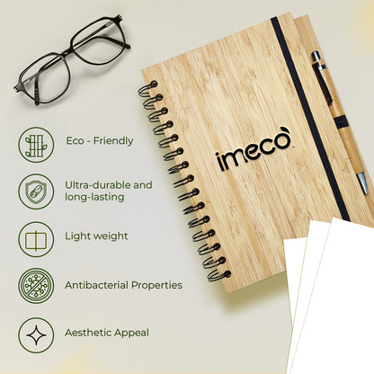 imeco bamboo diary with a pen with features mentioned and a glass is kept against a white background