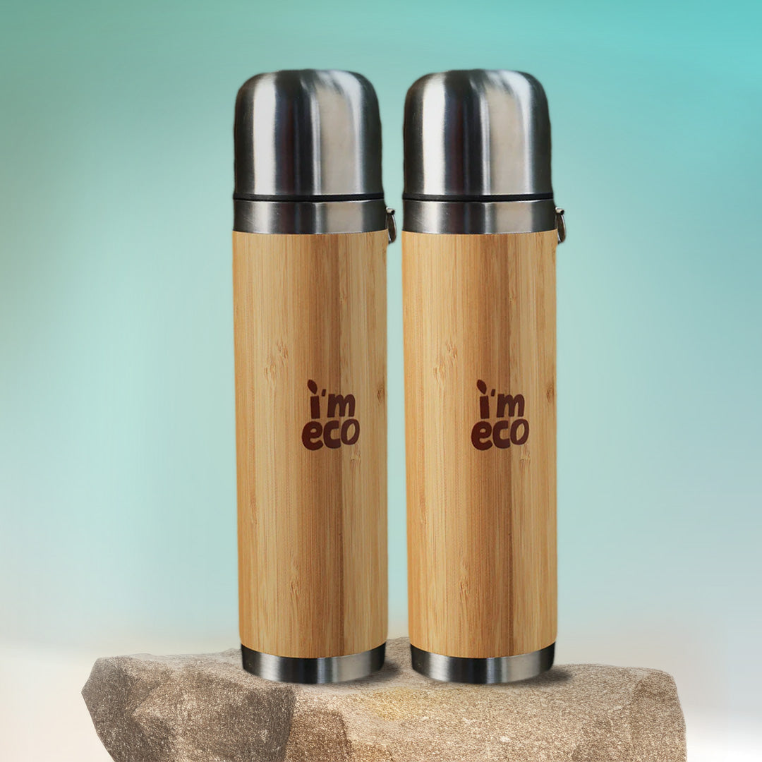 2 durable and eco-friendly bamboo thermos flasks are placed on a rock with a simple background.