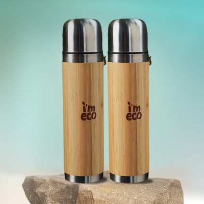 2 durable and eco-friendly bamboo thermos flasks are placed on a rock with a simple background.