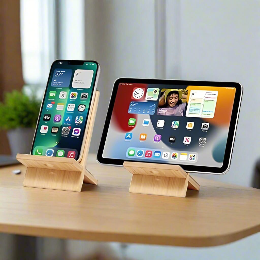 Two IMECO Bamboo Mobile Stands are there on one there is a mobile and on the other one there is iPad. Both of them are placed on office stand and in the background there is a blurry background 